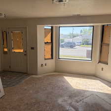 Entrance foyer featuring a textured ceiling and baseboards