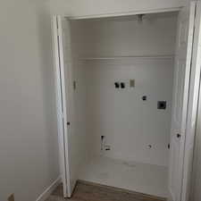 Laundry area featuring electric dryer hookup, washer hookup, light wood-type flooring, and gas dryer hookup