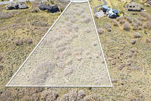 Aerial view of property and surrounding area featuring property parcel outlined