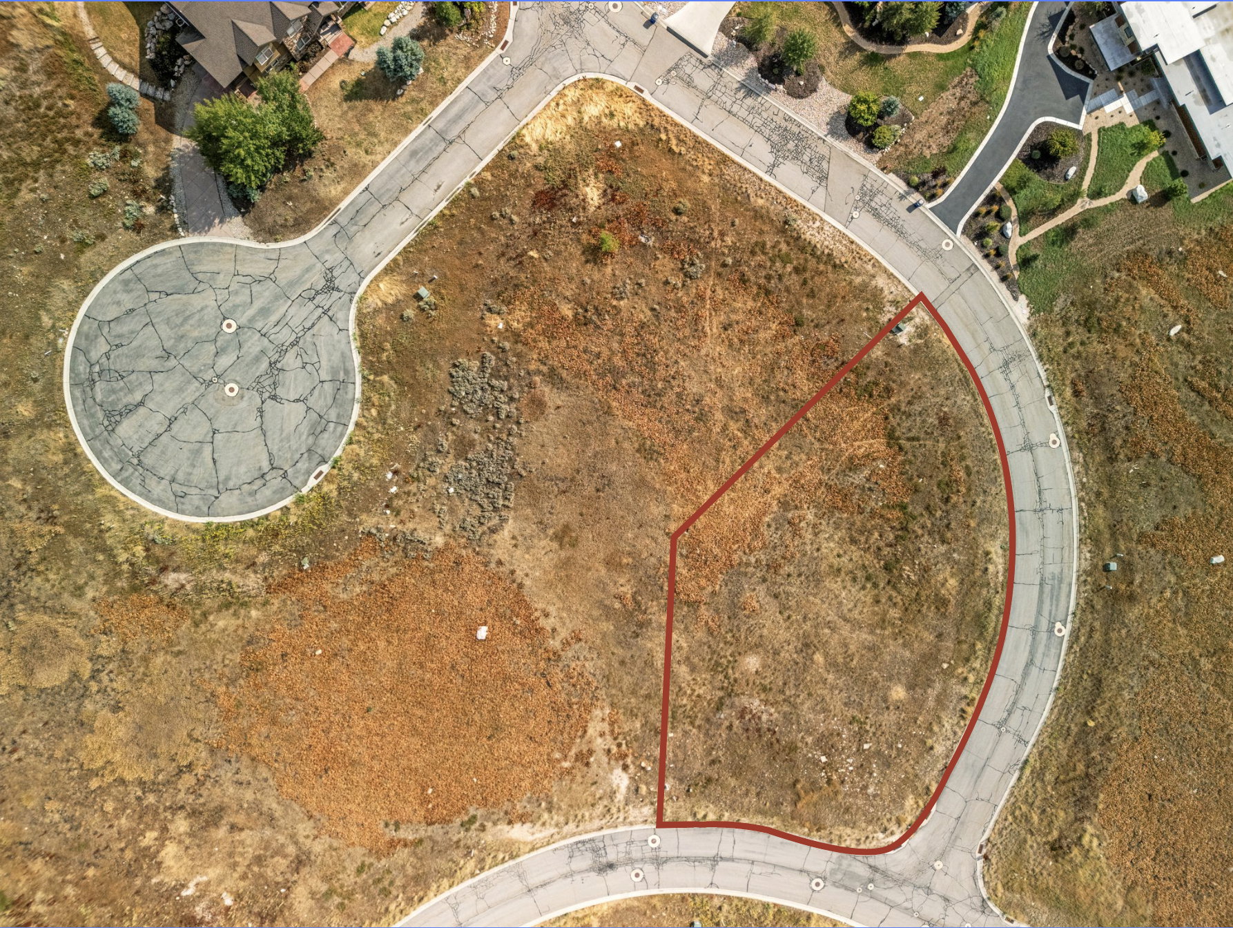 Expansive lot bordered by paved roads, featuring a cul-de-sac