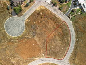 Expansive lot bordered by paved roads, featuring a cul-de-sac