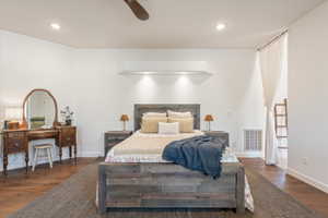 Recessed lighting illuminates a feature wall with an integrated shelf