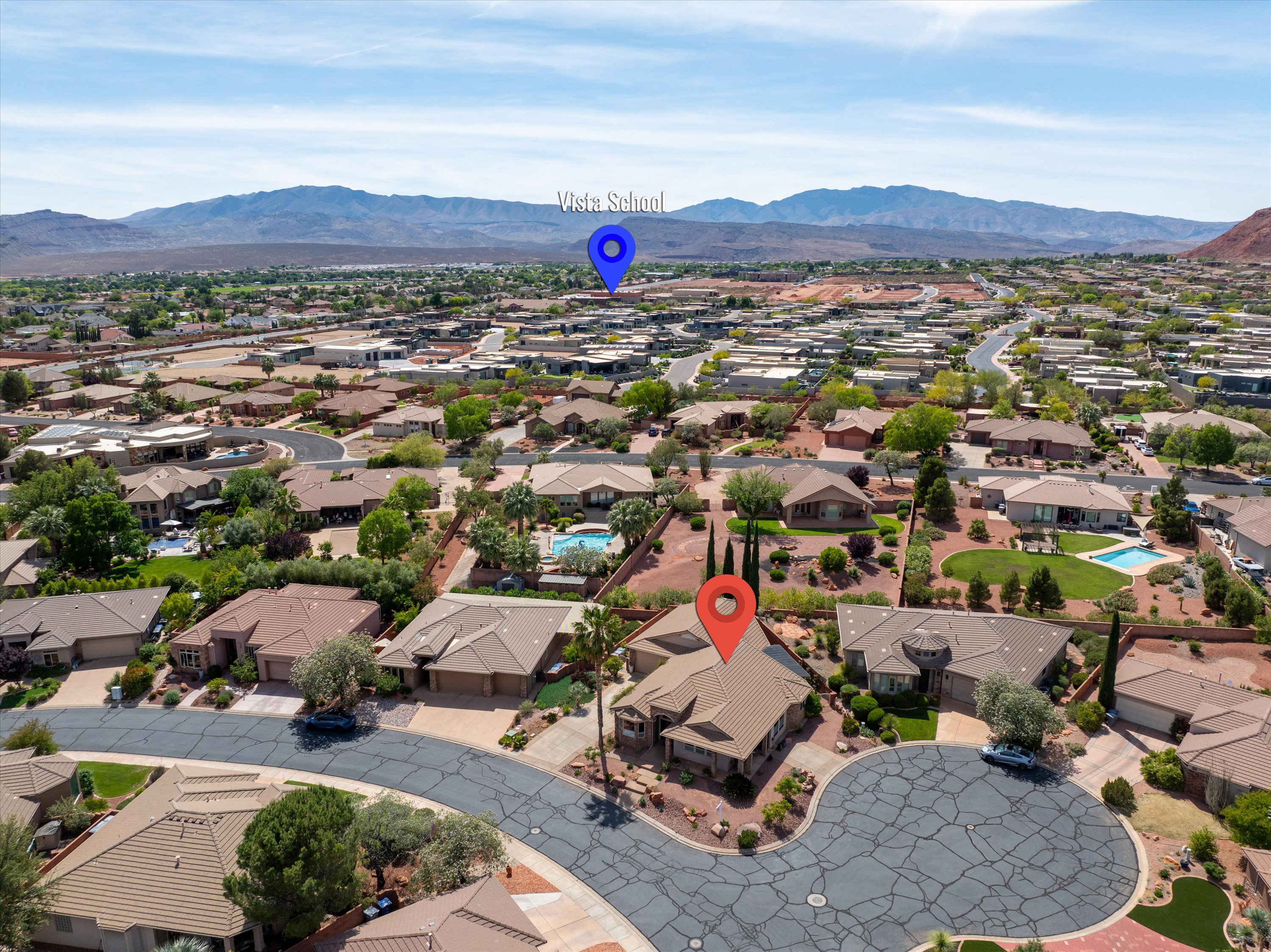 Aerial perspective of suburban area featuring a mountainous background