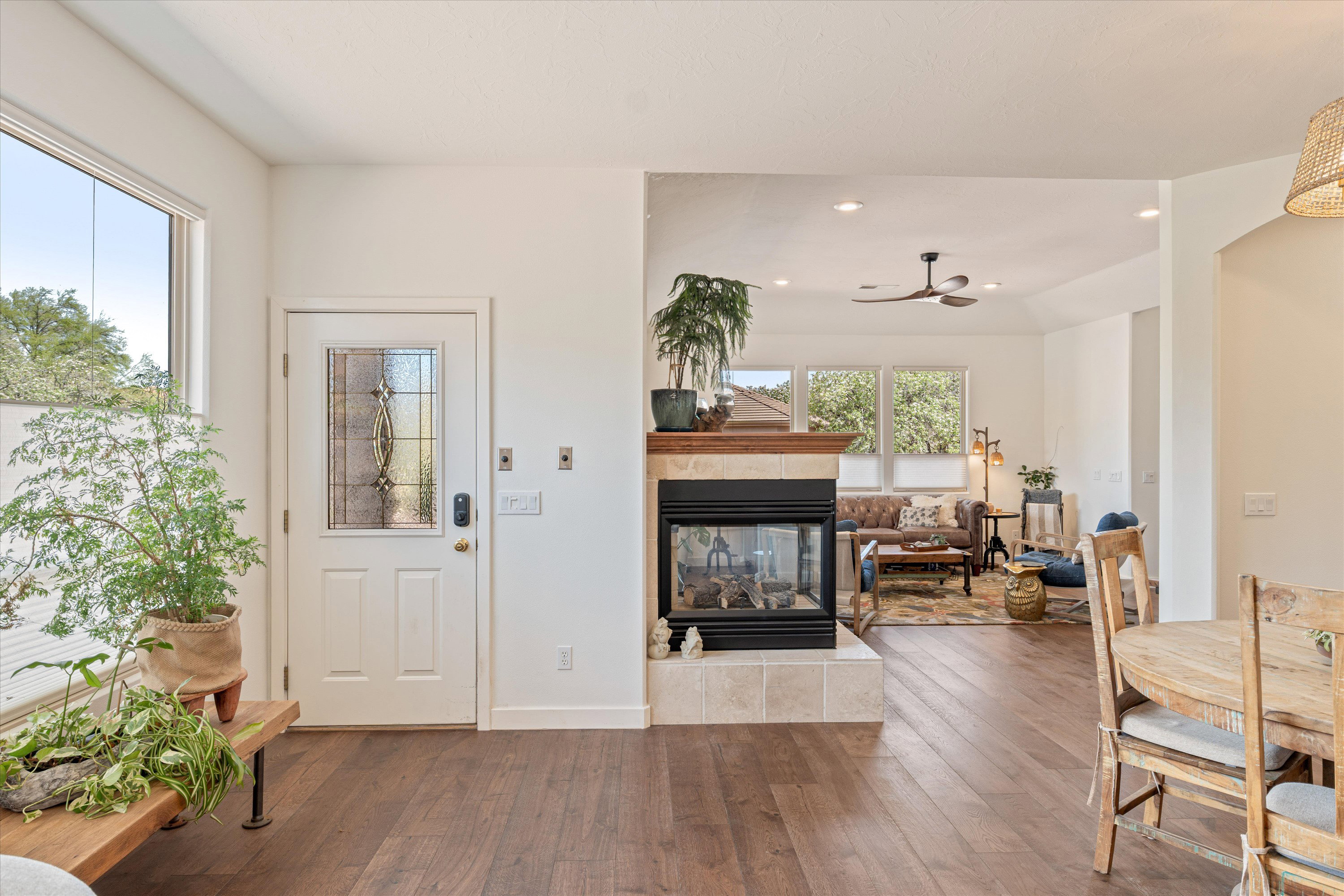 Entryway featuring hardwood / wood-style flooring, a fireplace, ceiling fan, and recessed lighting