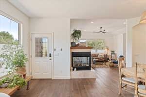 Entryway featuring hardwood / wood-style flooring, a fireplace, ceiling fan, and recessed lighting
