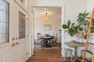 Dining room with dark wood finished floors and baseboards
