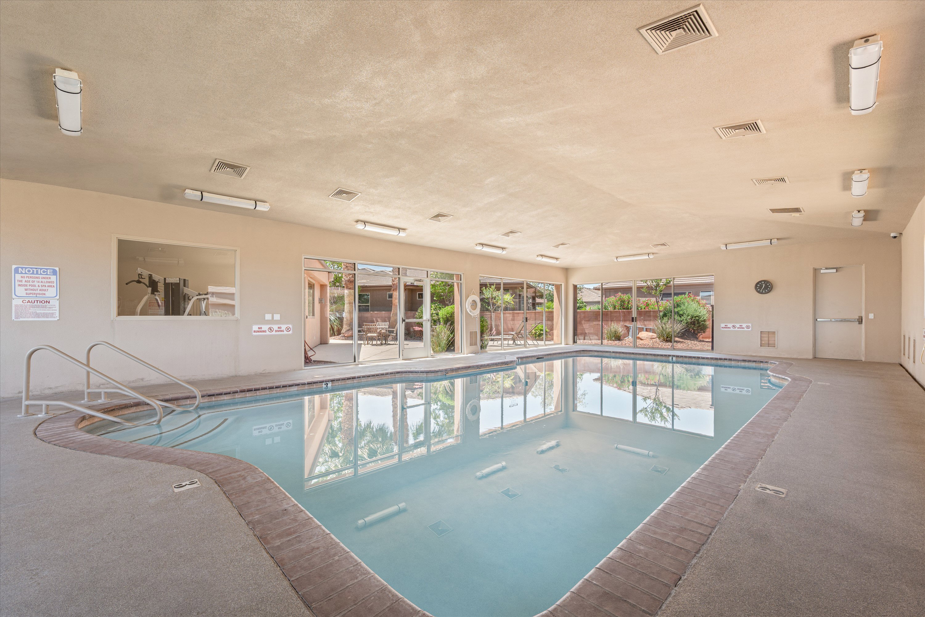 Indoor swimming pool with concrete decking and brick coping