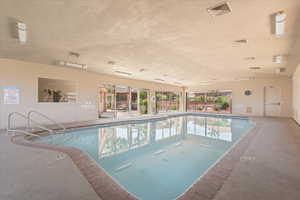 Indoor swimming pool with concrete decking and brick coping