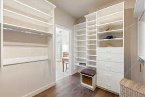 Custom closet system featuring extensive shelving, built-in drawers, and a hanging rod