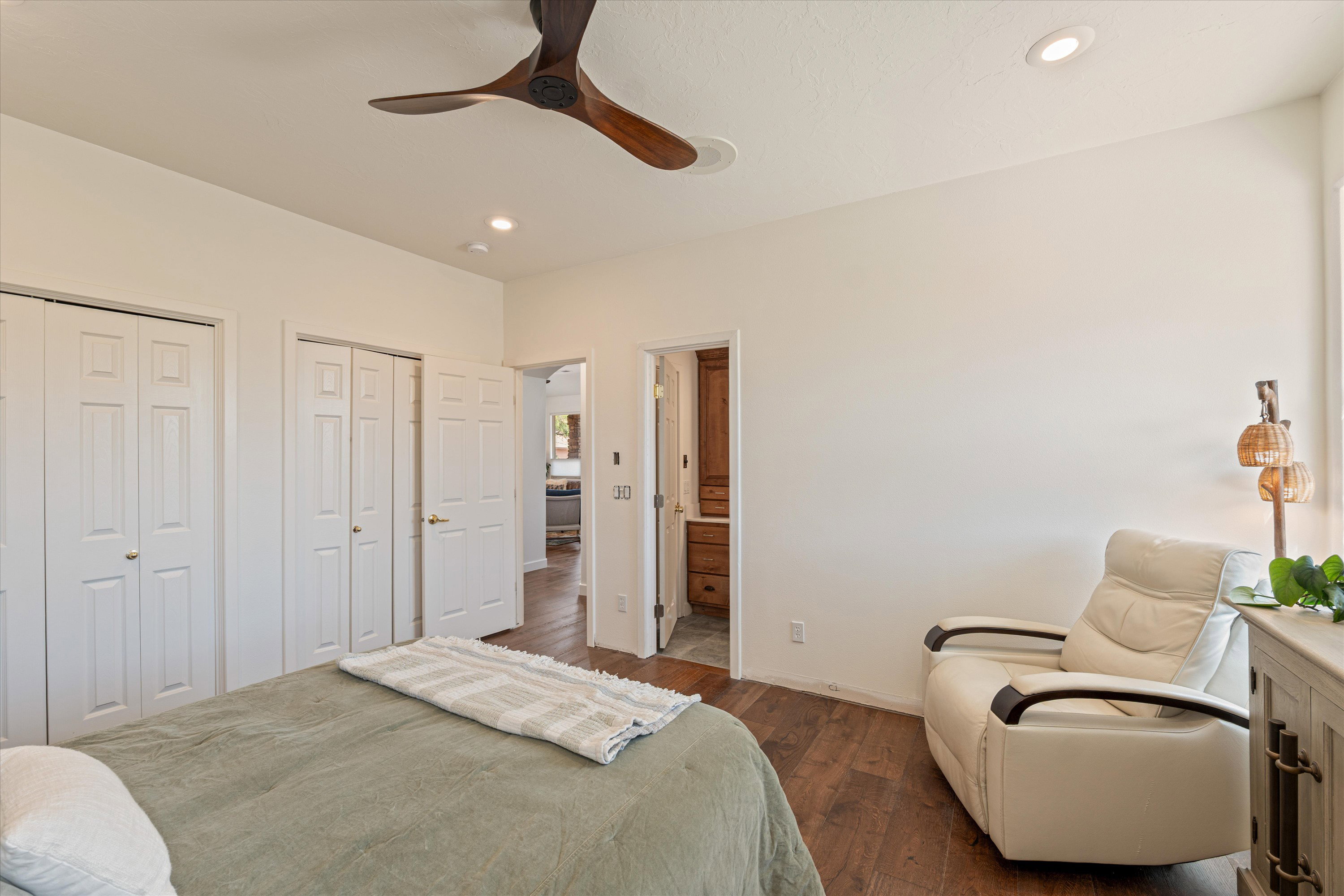 Bedroom featuring two closets, dark wood-style floors, ceiling fan, and recessed lighting