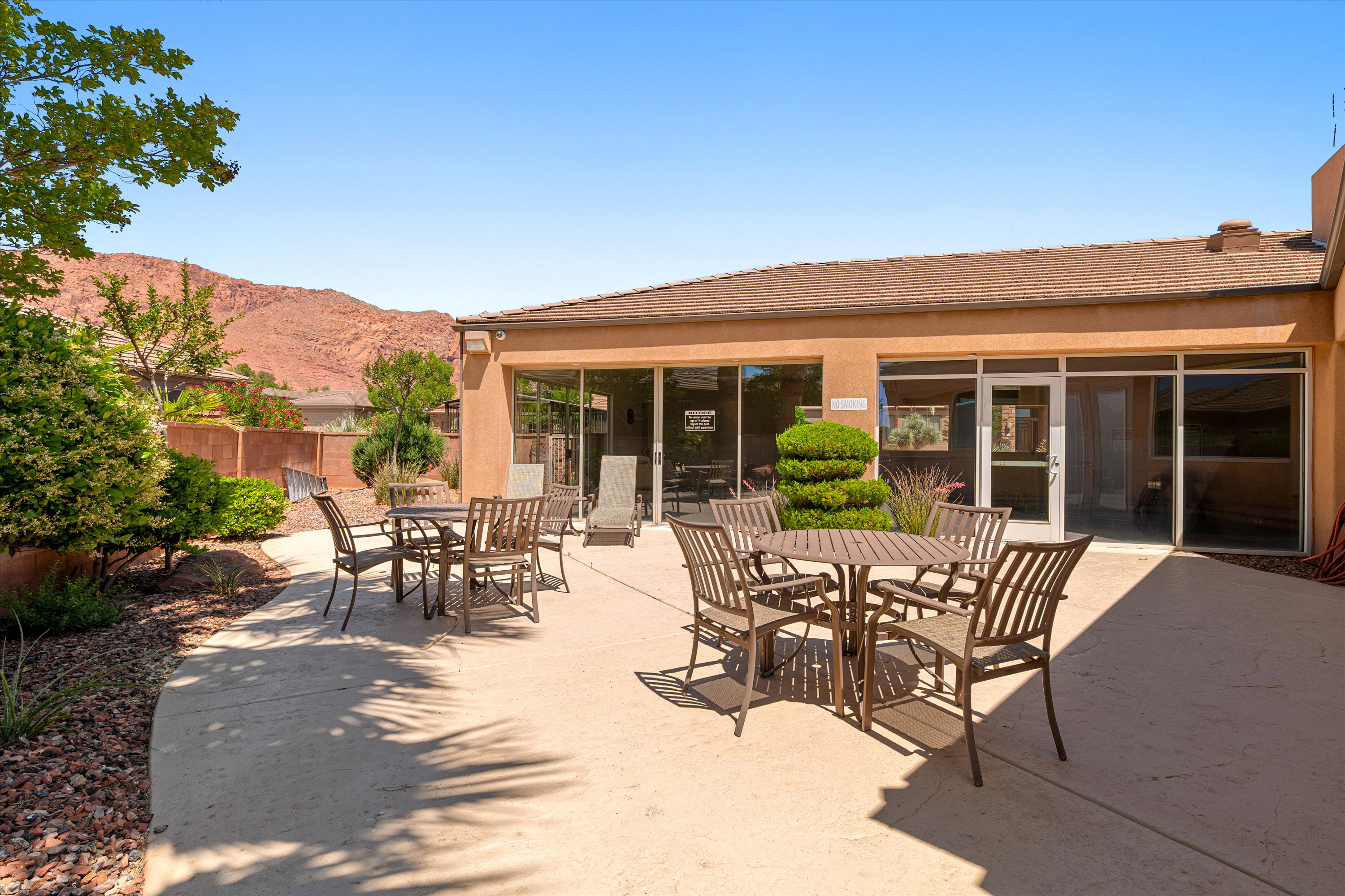 Expansive concrete patio with multiple outdoor seating areas
