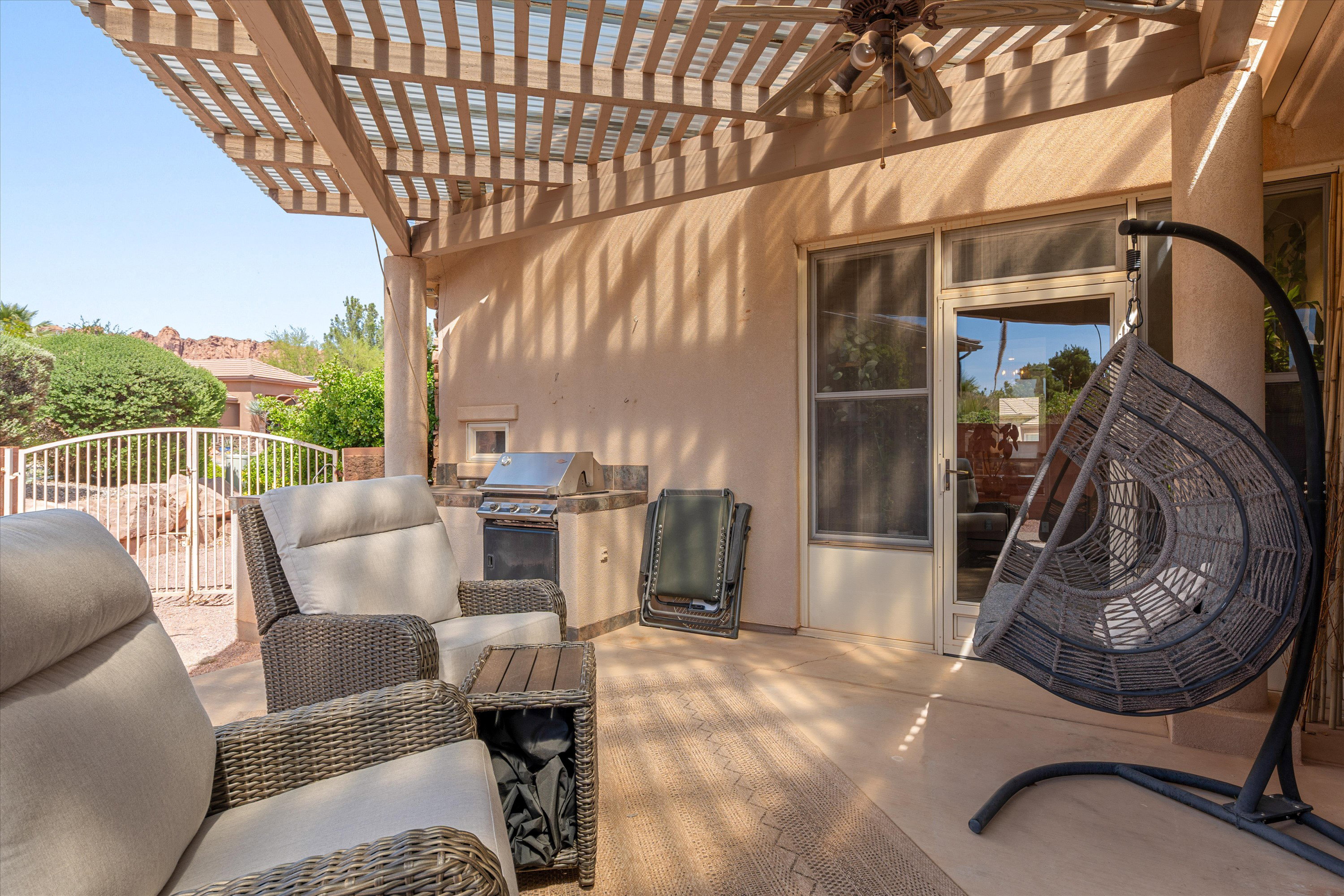 View of patio featuring area for grilling, a ceiling fan, and a pergola