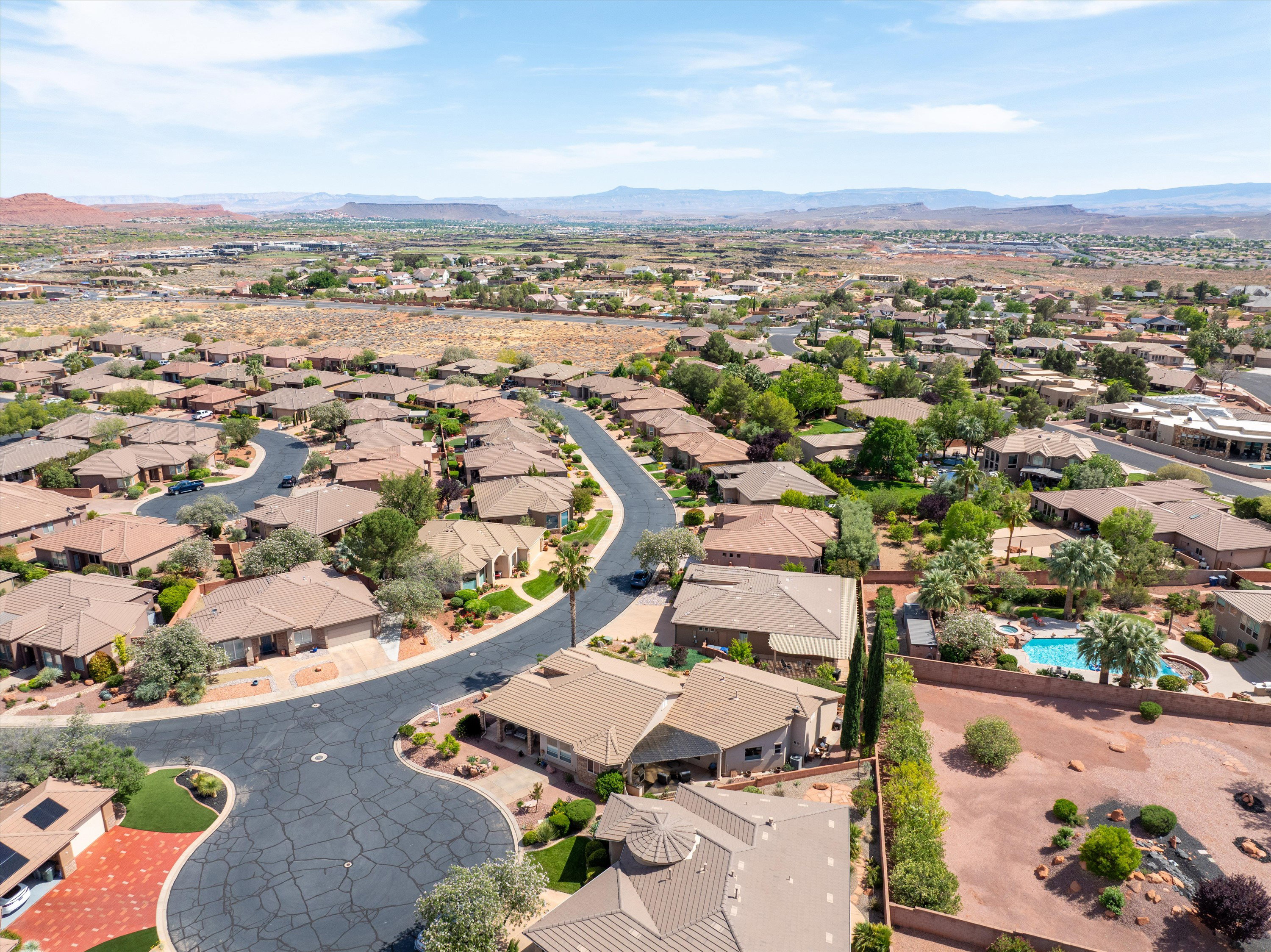 Aerial perspective of suburban area with a mountainous background
