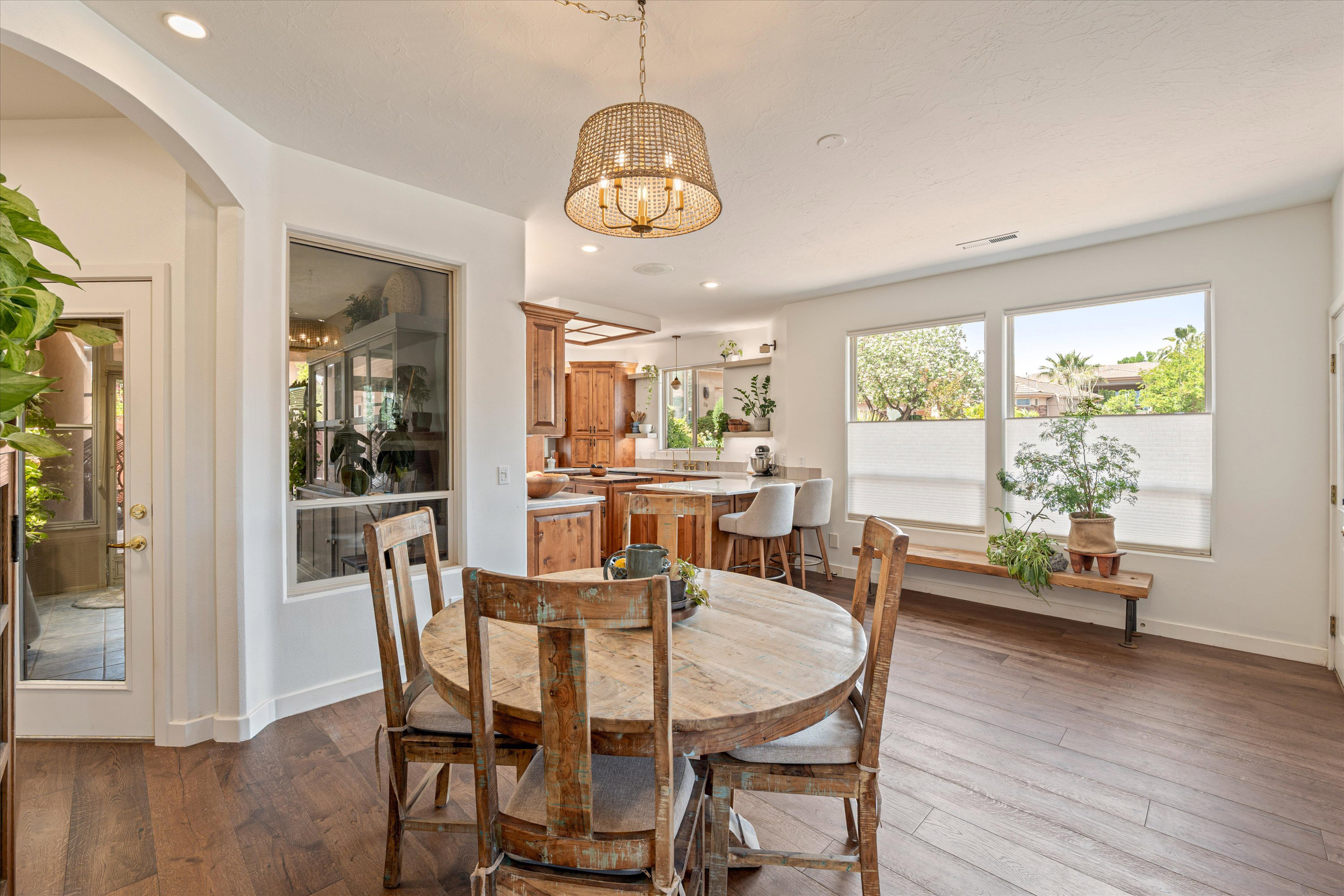 Dining space with hardwood / wood-style flooring and suspended lighting