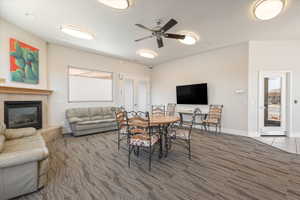 Spacious common area featuring a fireplace with a mantel, a large mounted television, and double glass-paneled doors