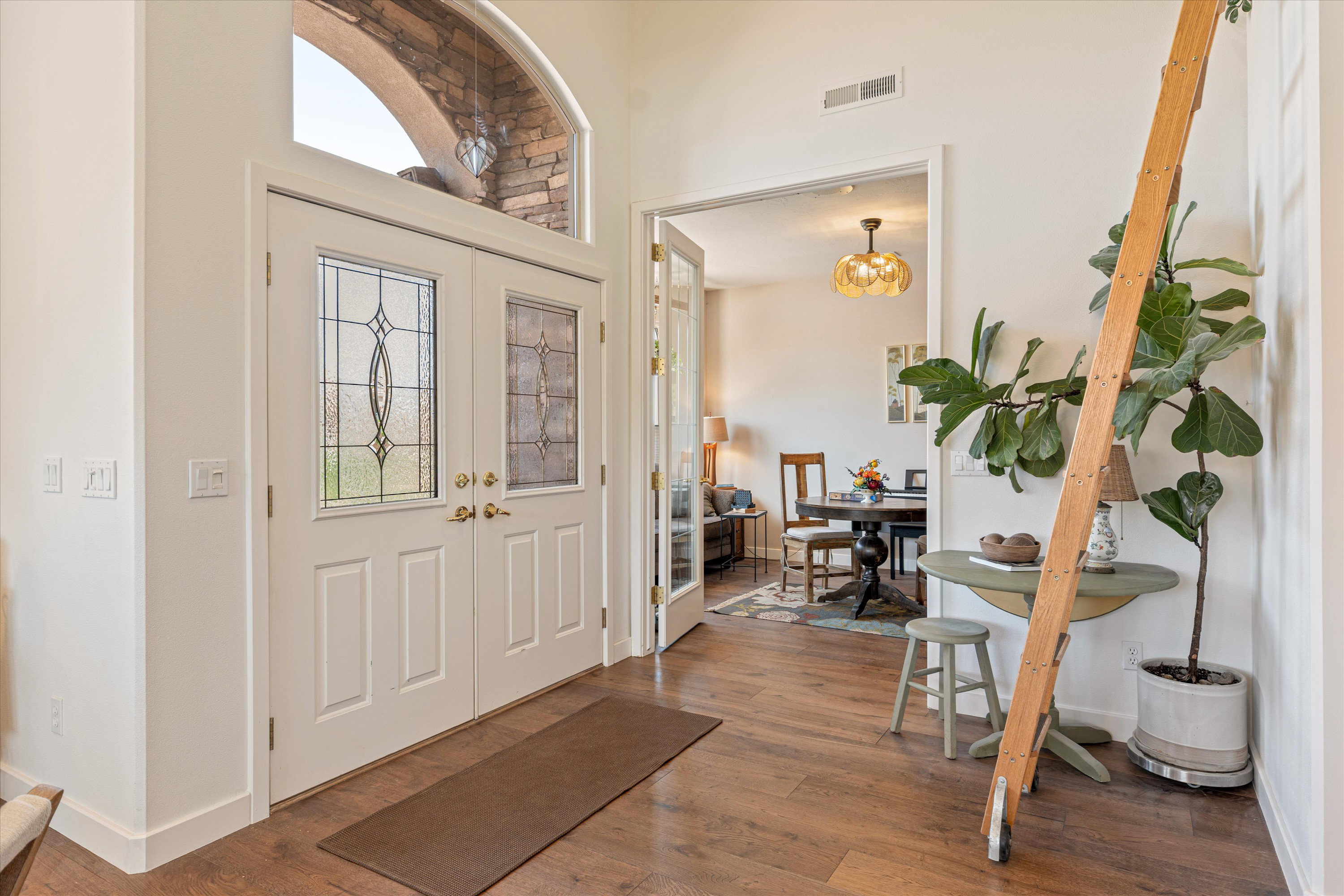 Foyer entrance featuring dark wood-type flooring and hanging lights