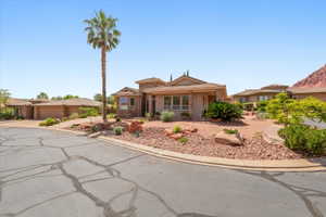 View of front of home featuring stucco siding and stone siding