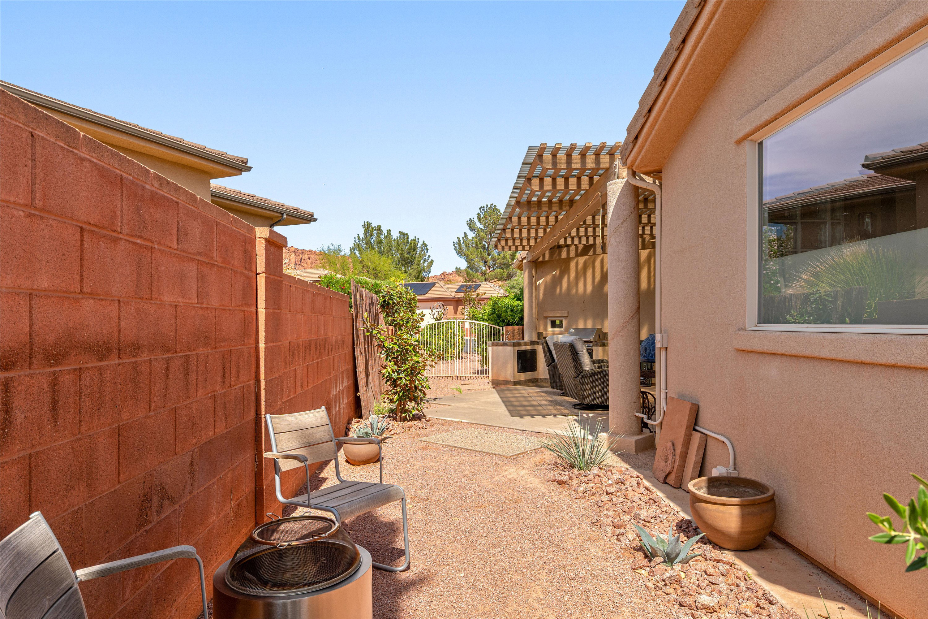 View of patio with a gate and a pergola