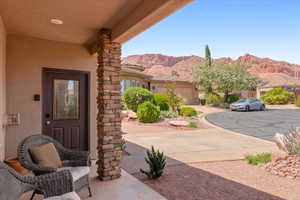 Doorway to property featuring stucco siding and a mountain view