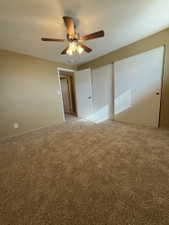 Spacious room featuring broadloom carpeting, a multi-speed ceiling fan with integrated lighting, and a neutral wall palette