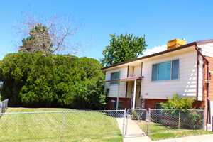 View of building exterior with a fenced front yard