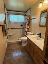 Walk-in shower with a built-in seat, a window feature, and grab bars