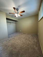 Room with neutral-toned walls and plush carpeting