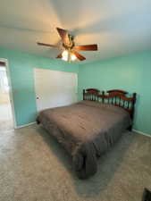 Carpeted room featuring a ceiling fan with integrated lighting, bi-fold closet doors, and light-colored walls