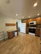 Kitchen featuring wood cabinetry, stone countertops, and wood type flooring.