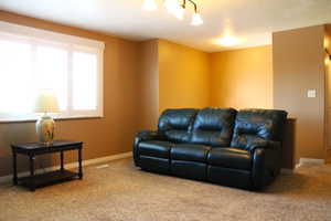 Living room with carpet floors and baseboards