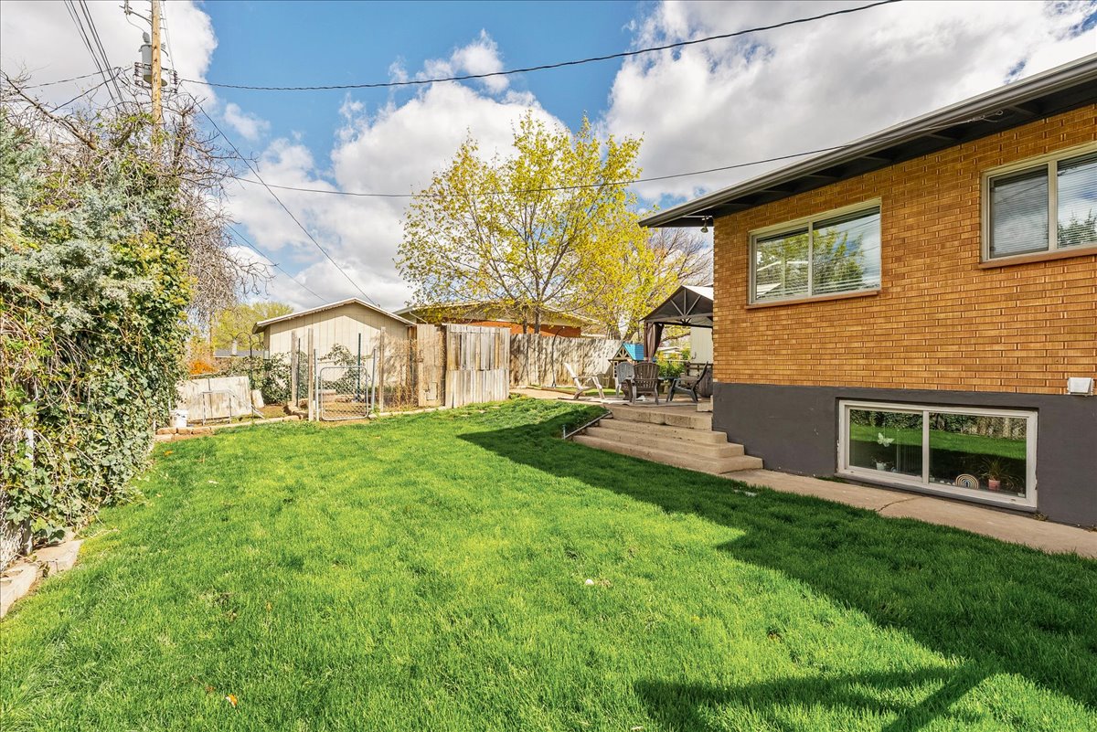 Fenced backyard featuring a gazebo