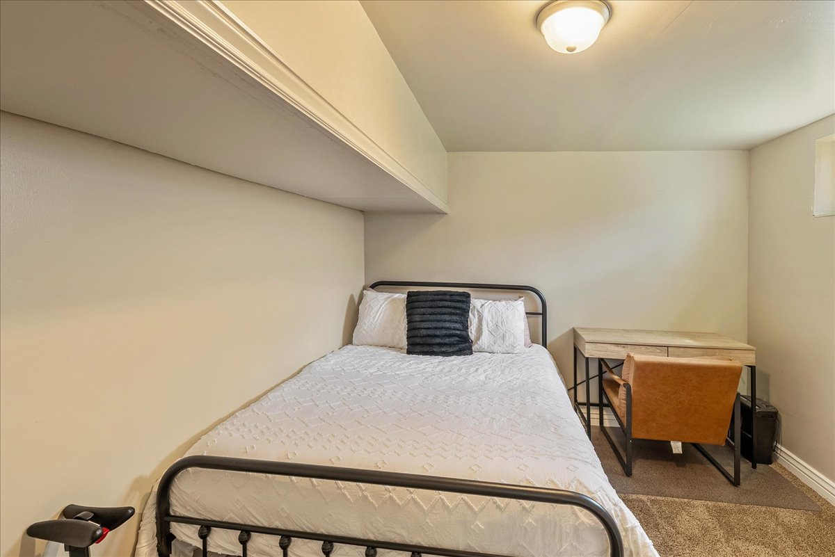 Bedroom featuring carpet flooring and baseboards