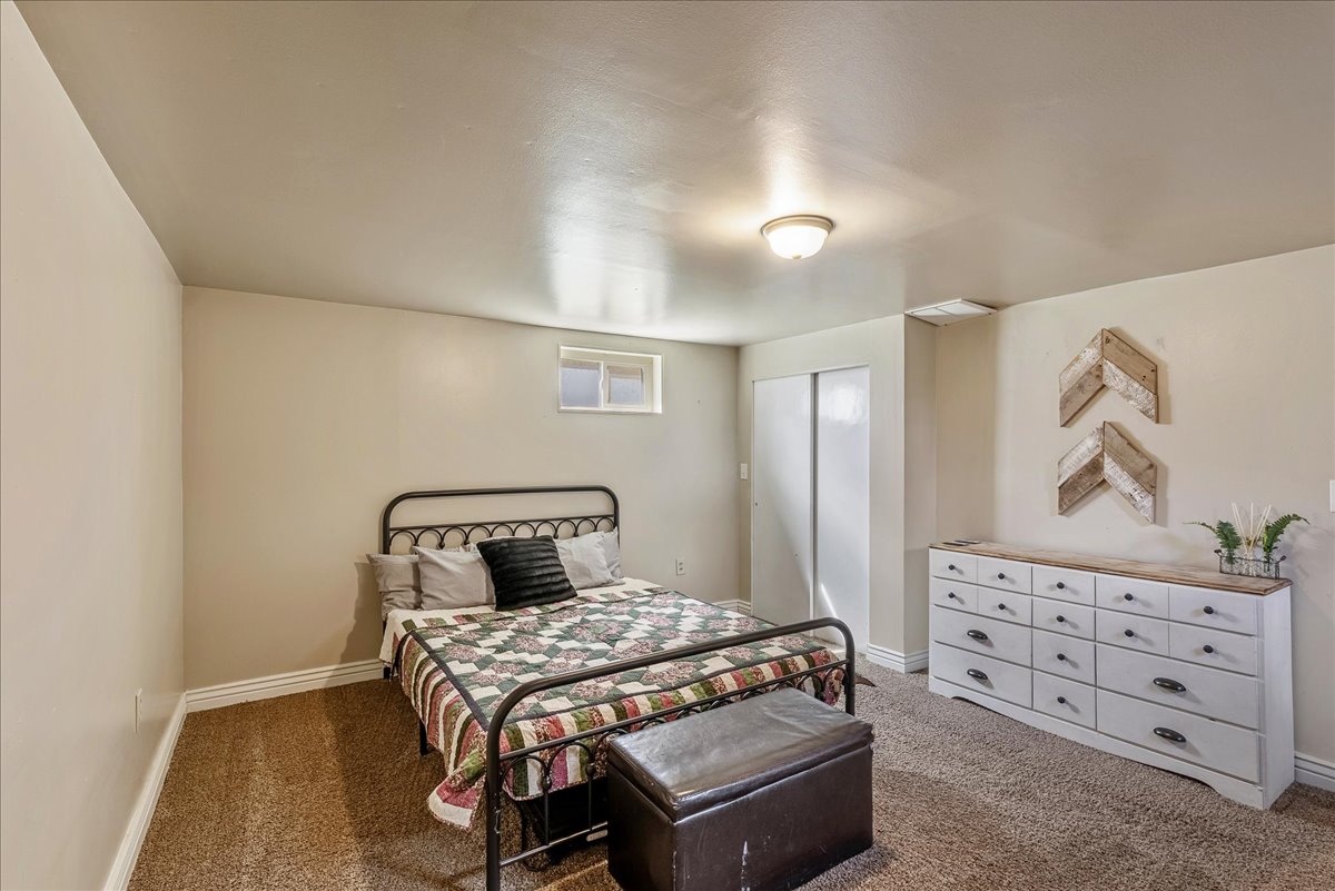 Bedroom featuring carpet and a closet