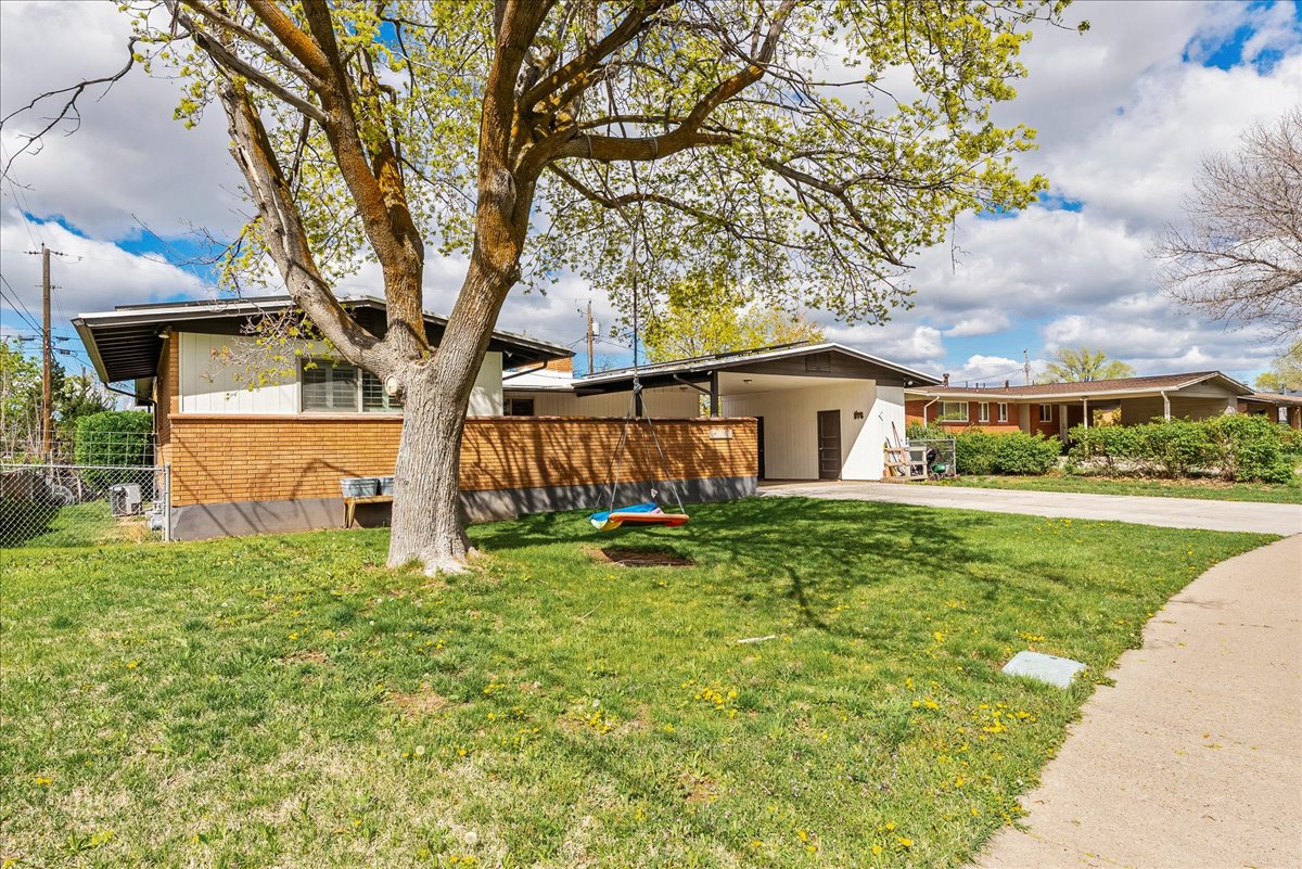 View of front facade with concrete driveway and brick siding