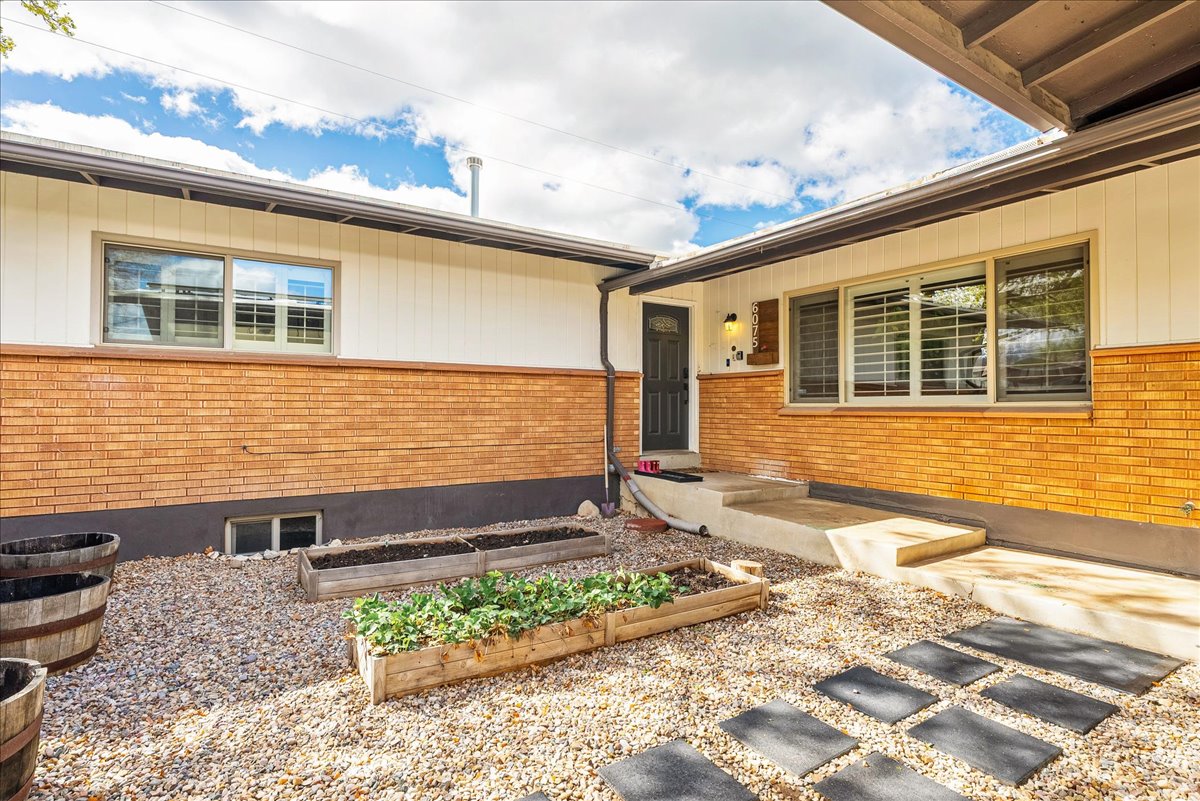 View of exterior entry featuring brick siding