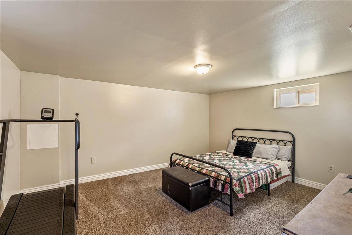 Bedroom featuring dark carpet