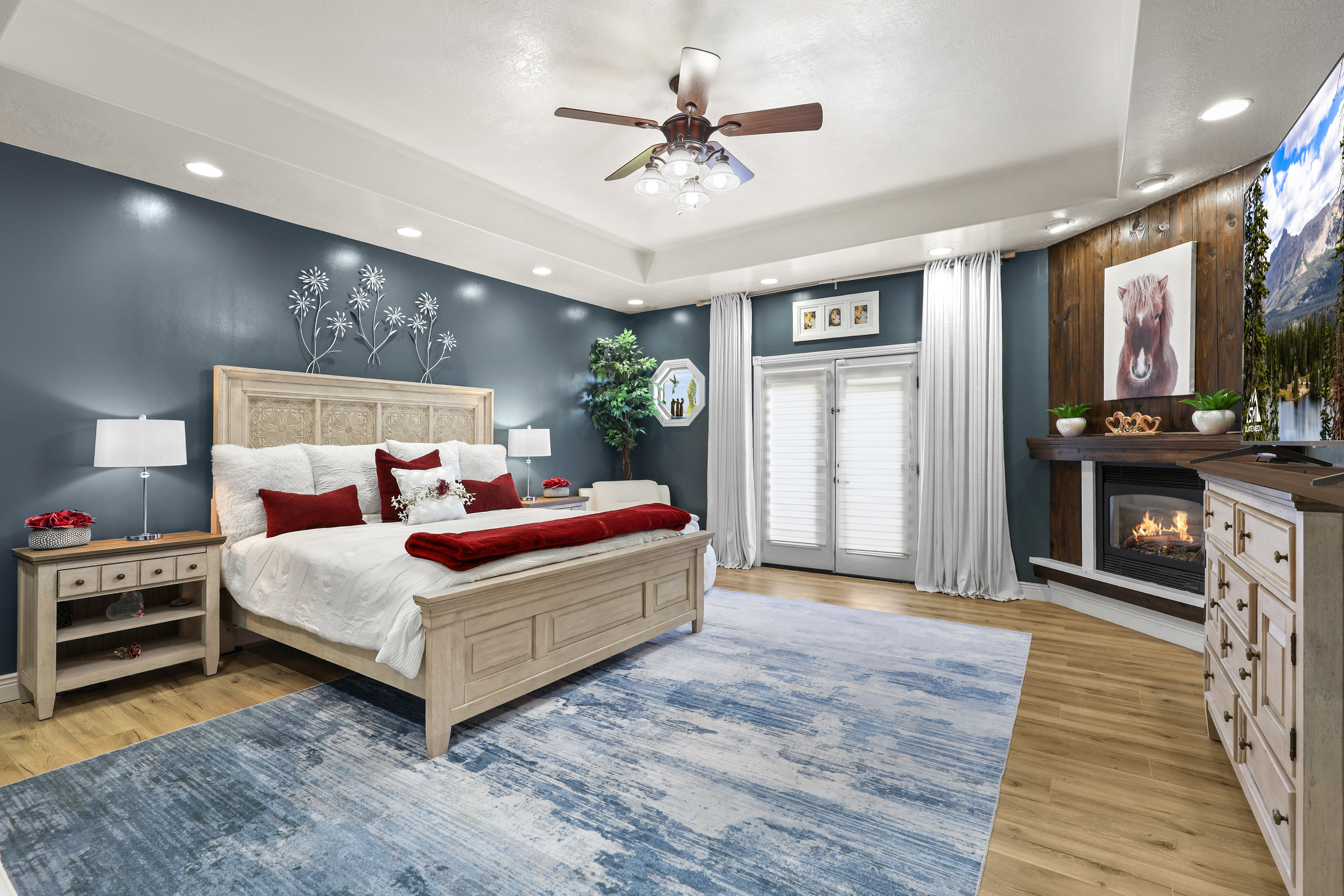 Bedroom featuring access to outside, recessed lighting, ceiling fan, light wood-style floors, and a glass covered fireplace