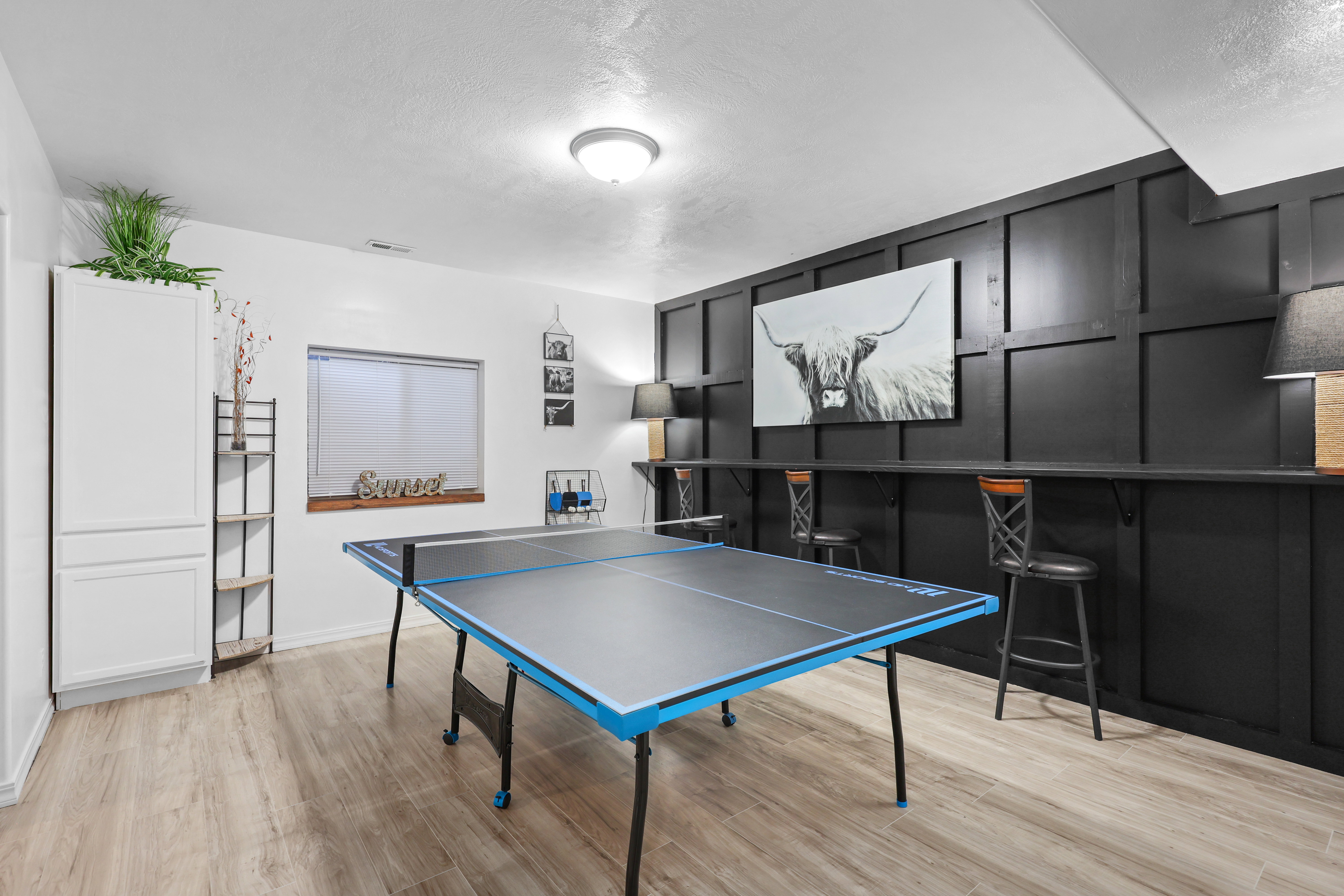 Rec room featuring light wood-style flooring and a textured ceiling