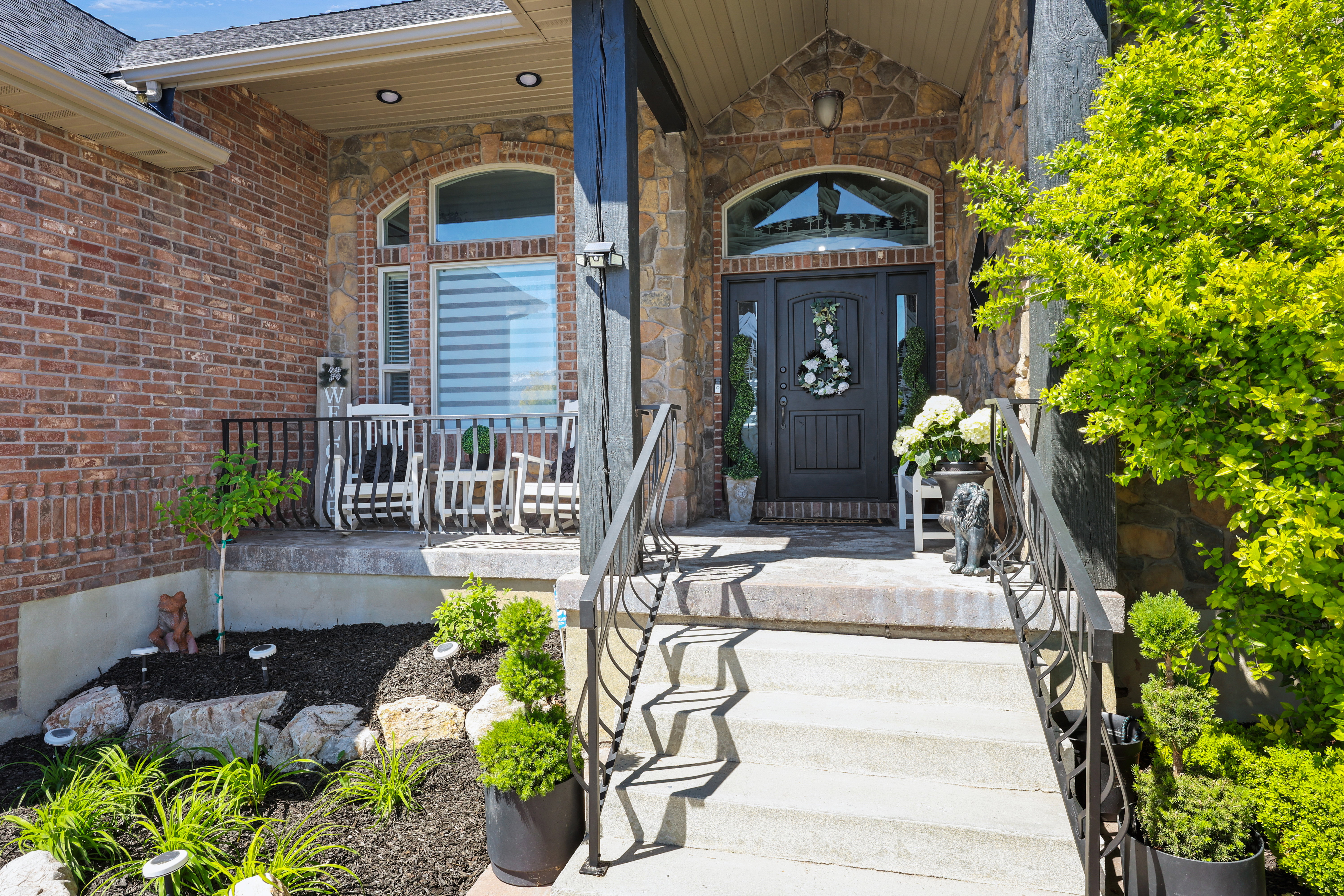 Entrance to property featuring covered porch and brick siding