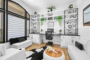 Office featuring built in study area and light wood finished floors