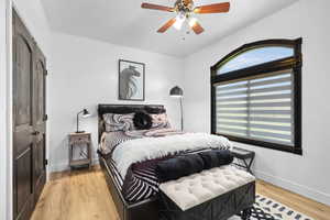 Bedroom featuring a closet, light wood-style flooring, and a ceiling fan