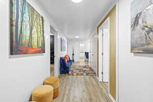 Corridor featuring light wood finished floors and baseboards