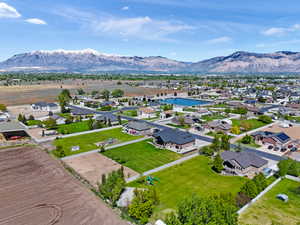 Aerial view of property's location featuring a mountain backdrop and nearby suburban area