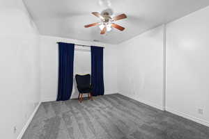 Unfurnished room with carpet and a ceiling fan