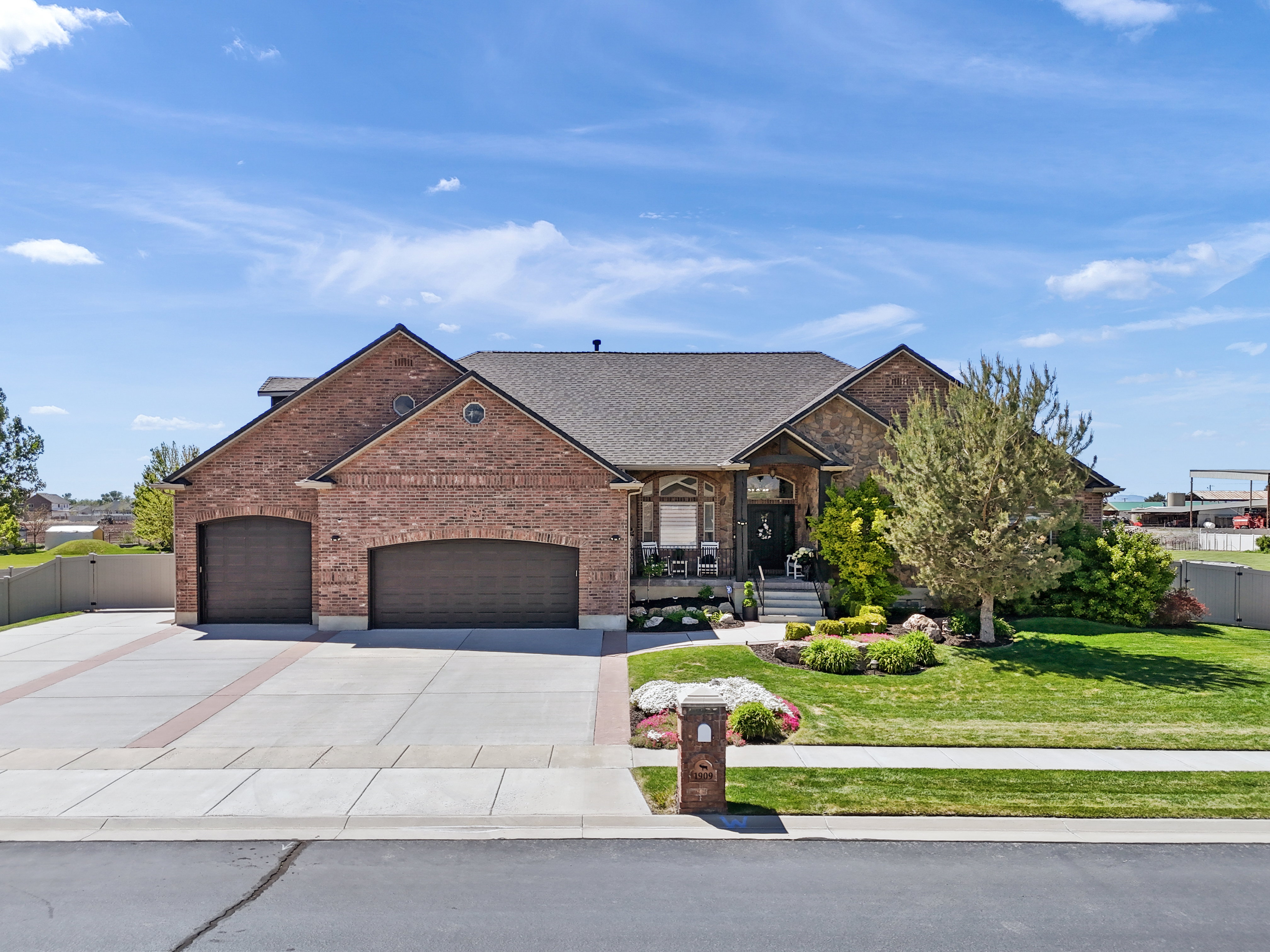 View of front of house featuring a porch, a garage, brick siding, concrete driveway, and a shingled roof