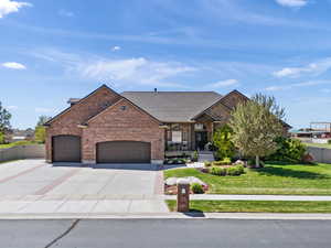 View of front of house featuring a porch, a garage, brick siding, concrete driveway, and a shingled roof