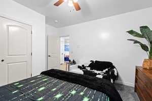 Carpeted bedroom with baseboards and a ceiling fan