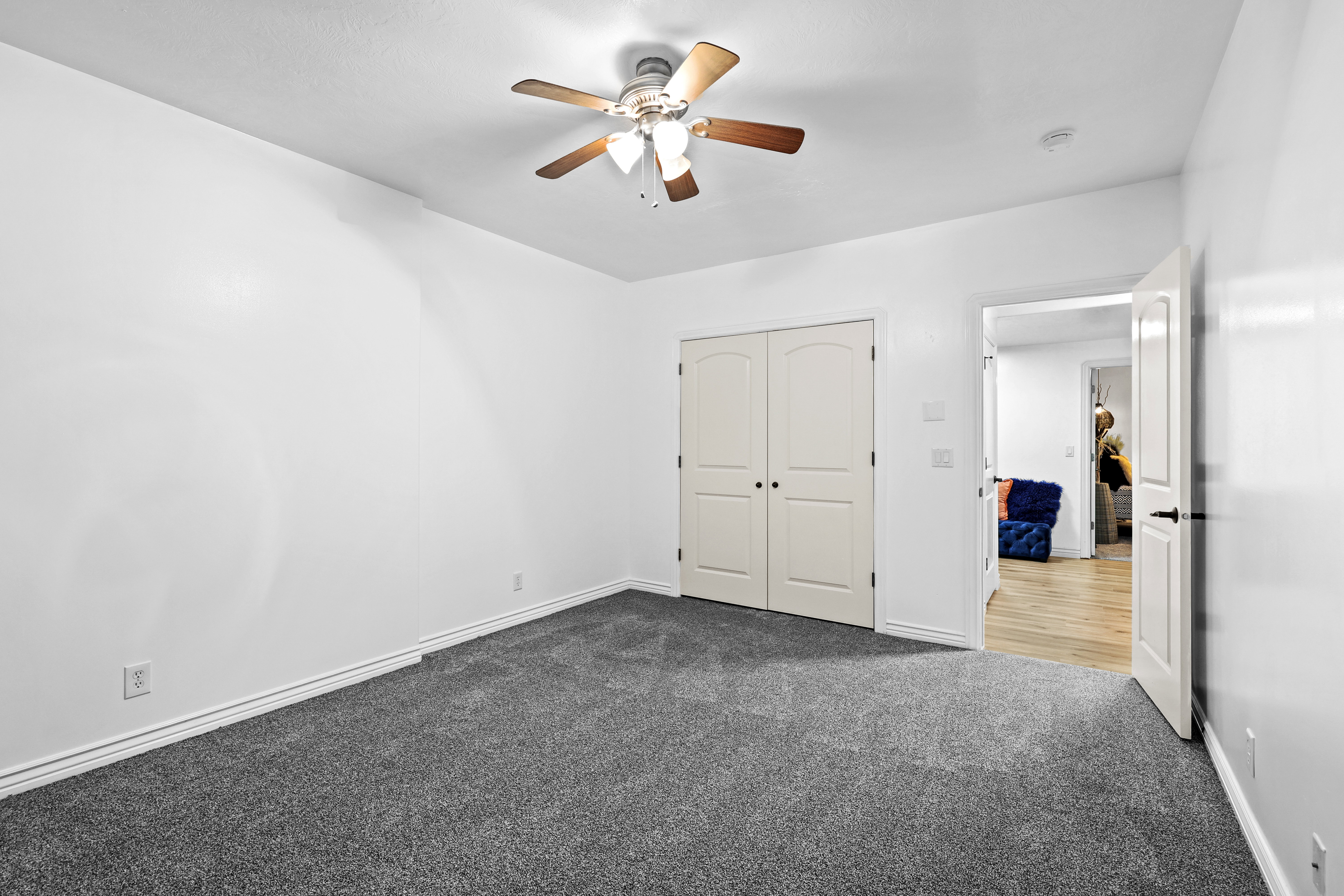 Unfurnished bedroom featuring carpet flooring, a ceiling fan, and a closet