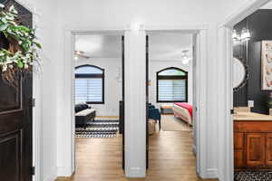 Corridor with light wood-style floors and baseboards