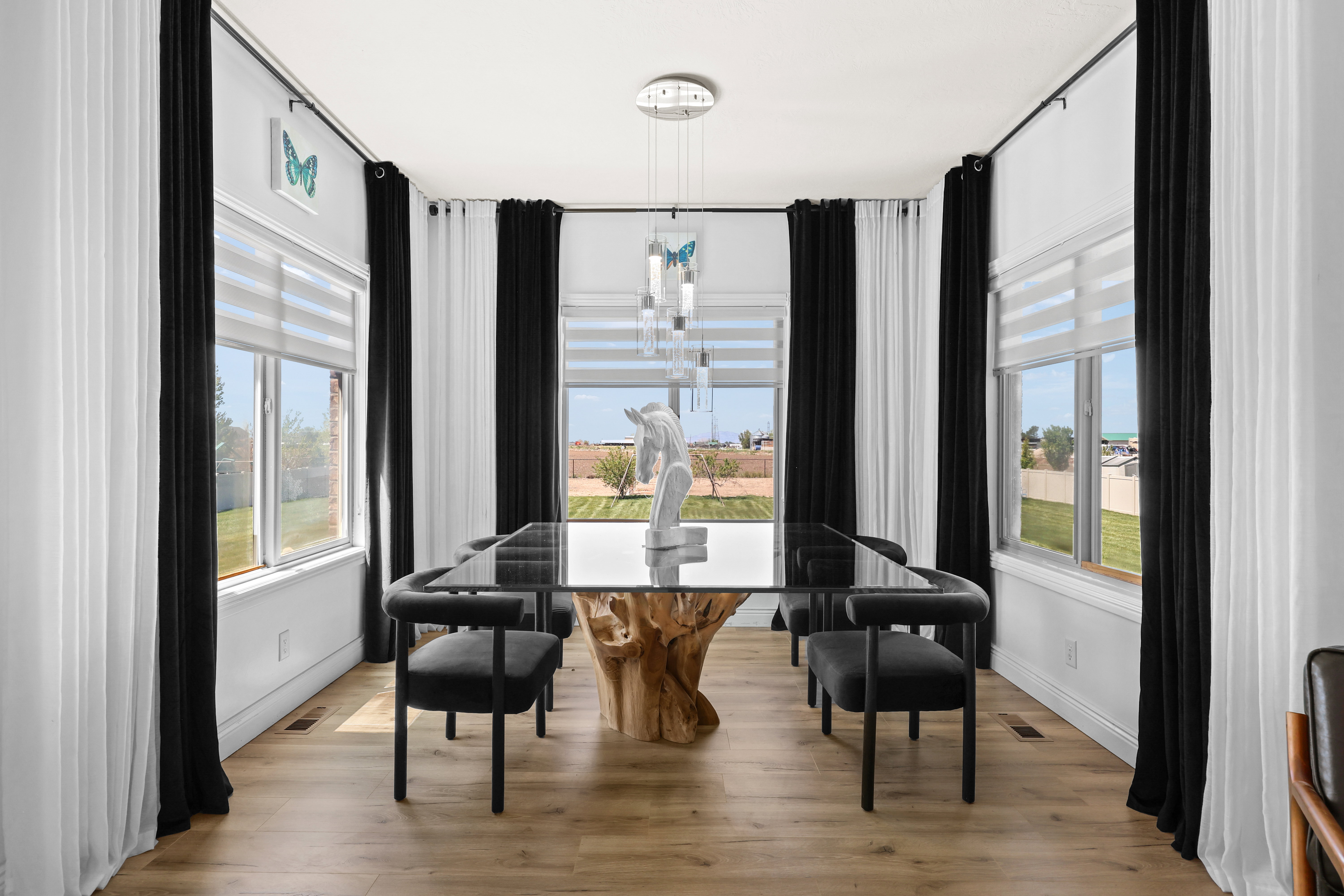 Dining room with light wood-type flooring, plenty of natural light, and hanging lights